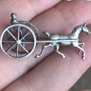 This is stunning sterling silver brooch featuring a two-wheel chariot horse